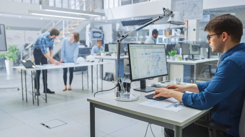 Group of engineers in an office managing their drawings using AutoCAD.