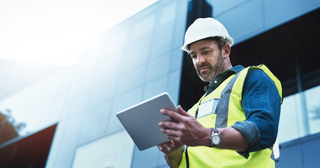 Male FM working on a tablet computer while conducting preventive maintenance.