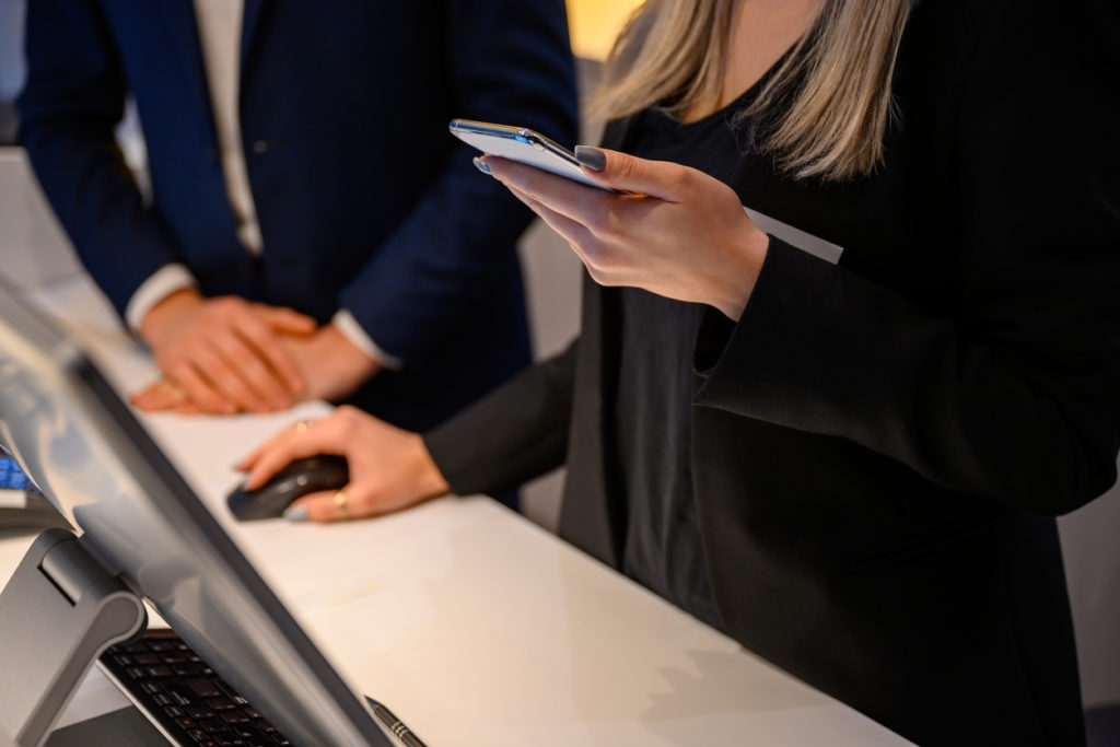 Hotel employees using computers with CAFM software to acquire information about room configuration and setup.