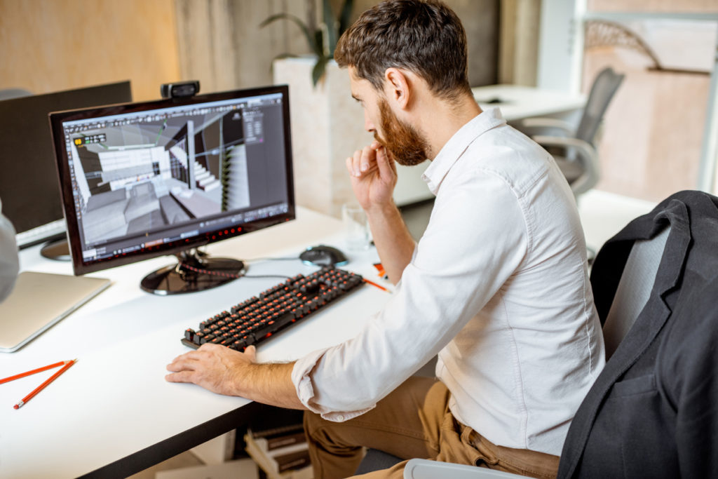 Male architect working on a project using digital design software to come up with architectural renderings.